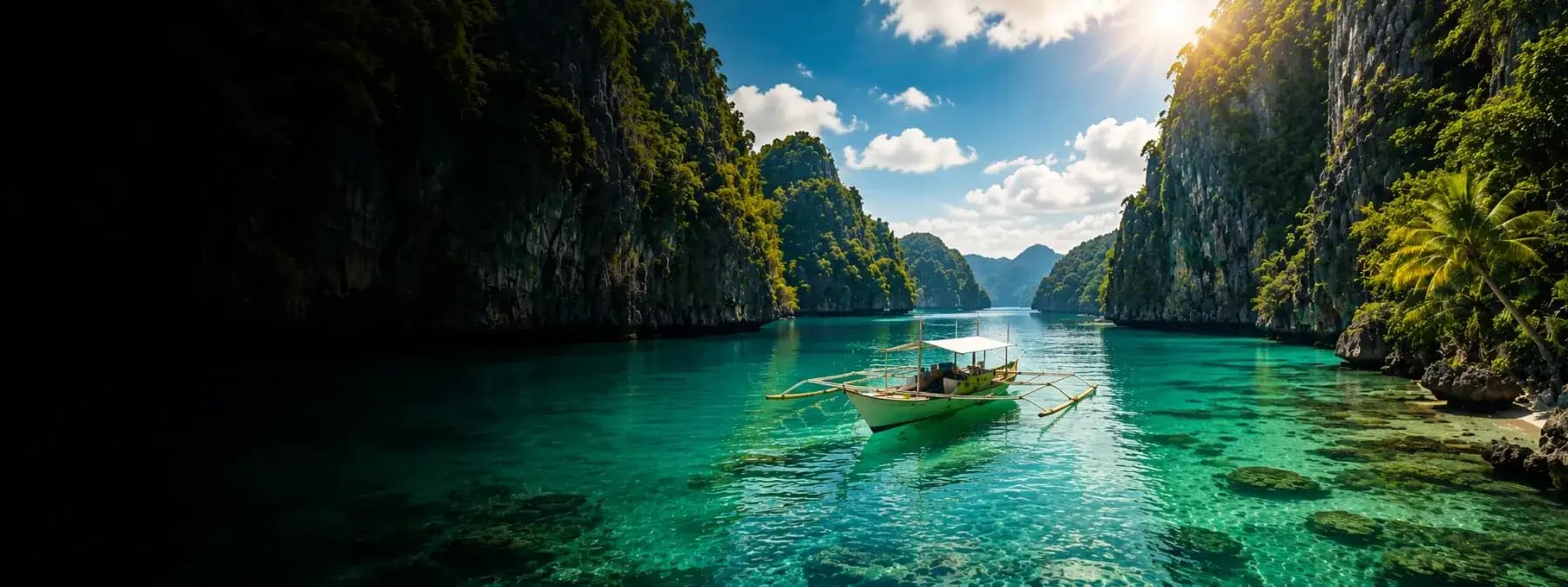 A lagoon between two limestone cliffs in El Nido, with one outrigger boat on turquoise water.